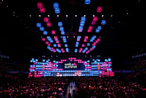 Photo of stage at Web Summit, with a packed audience.