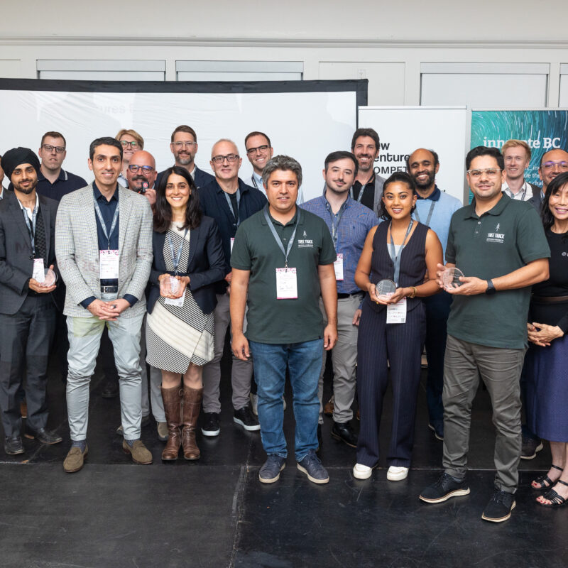 The 2024 Top 10 finalists posing together for a group photo, smiling proudly. They are standing in front of an event backdrop.