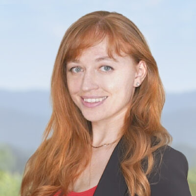 Headshot of Liuba Mamonova, COO, in front of an exterior background.