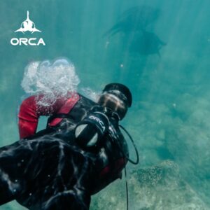 Scuba diver in crystal clear water, using ORCA’s underwater equipment.
