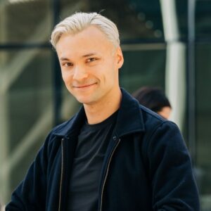 Headshot of Nathan Tran, CEO and Founder, smiling at the camera.